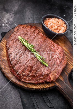 Grilled Flank Flap beef steak, showcasing beautiful grill marks. black background. top view Grilled Flank Flap beef steak, showcasing beautiful grill marks. black background. top view 137438269