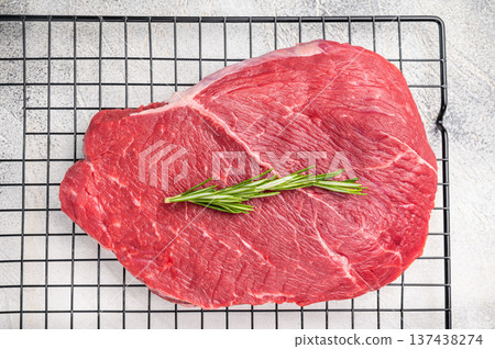 A close up of raw top sirloin beef steak, showcasing its rich color and tender texture, ideal for gourmet cooking. white background. top view A close up of raw top sirloin beef steak, showcasing its rich color and tender texture, ideal for gourmet cooking. white background. top view 137438274