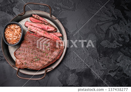 Succulent grilled top sirloin steak, cooked to perfection and drizzled with a rich sauce for an unforgettable dining experience. black background. top view Succulent grilled top sirloin steak, cooked to perfection and drizzled with a rich sauce for an unforgettable dining experience. black background. top view 137438277