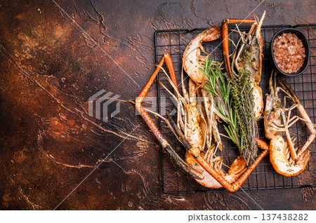 Savory grilled rosenbergii prawn drizzled with garlic butter, a luxurious treat for any seafood enthusiast. brown background. top view Savory grilled rosenbergii prawn drizzled with garlic butter, a luxurious treat for any seafood enthusiast. brown background. top view 137438282