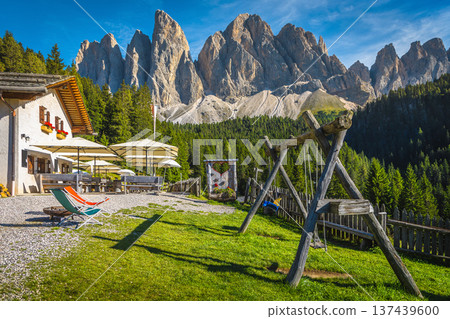 Alpine restaurant with outdoor resting place in the Dolomites, Italy 137439600