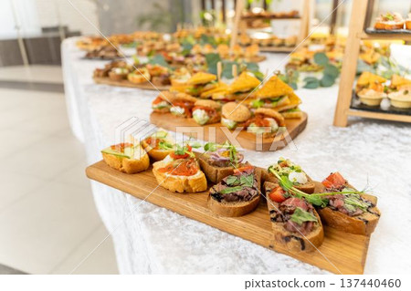Gourmet buffet table with assorted bruschetta, canape and mini sandwich Gourmet buffet table with assorted bruschetta, canape and mini sandwich 137440460