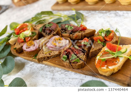 Assorted gourmet bruschetta with meat, tomato, onion, and cheese Assorted gourmet bruschetta with meat, tomato, onion, and cheese 137440464