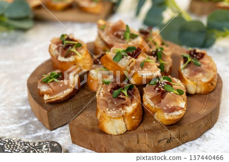 Gourmet bruschetta with prosciutto, cream cheese, sun-dried tomatoes Gourmet bruschetta with prosciutto, cream cheese, sun-dried tomatoes 137440466