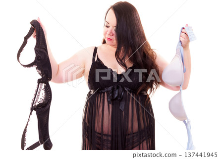 Woman choosing witch bra to wear. Woman choosing witch bra to wear. 137441945