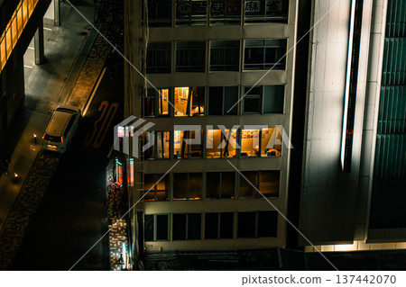夜幕降臨，城市景觀盡收眼底，燈火通明的多戶住宅大樓和幽暗的小巷交錯而過。 137442070