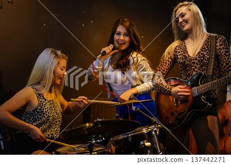 Woman singing, band playing instruments. Woman singing, band playing instruments. 137442271