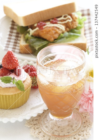 Fried chicken sandwich and strawberry cupcake 137442549