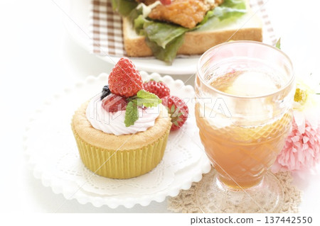 Fried chicken sandwich and strawberry cupcake Fried chicken sandwich and strawberry cupcake 137442550