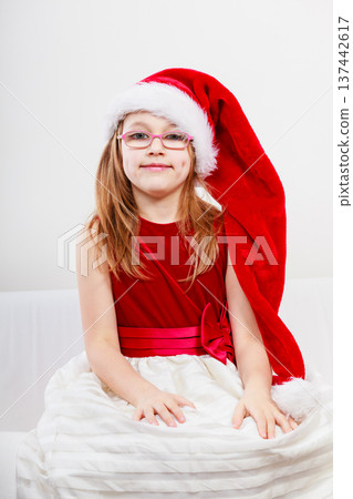 Christmas girl in santa hat festive outfit Christmas girl in santa hat festive outfit 137442617