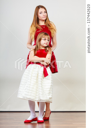 Mother and daughter posing together Mother and daughter posing together 137442620