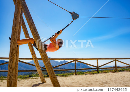 Adult woman having fun on zipline Adult woman having fun on zipline 137442635