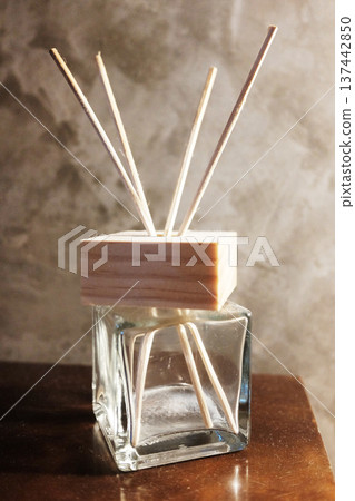 Air refresher or home fragrance Diffuser with reed sticks on wooden table 137442850