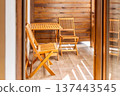 balcony with wooden table and chairs 137443545