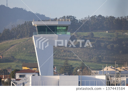 Modern airport control tower overseeing air traffic operations 137443584