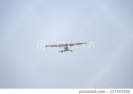 Small airplane flying in clear blue sky Small airplane flying in clear blue sky 137443588