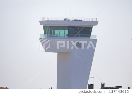 Modern air traffic control tower guiding airport operations 137443615