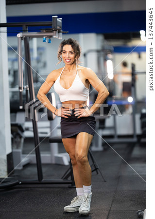 Fit woman posing in gym showing strong body and confidence 137443645