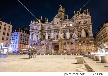 Lyon, france. December 27,2023. Lyon city hall at place des terreaux at night, historic illuminated facade with long exposure motion blur and cobblestone square 137443920