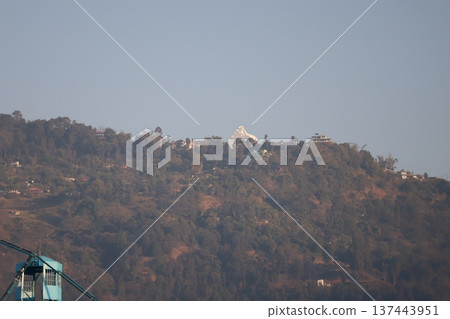 A view of the sharp snow-capped Himalayan mountains and the sky on top of a mountain with houses in Pokhara A view of the sharp snow-capped Himalayan mountains and the sky on top of a mountain with houses in Pokhara 137443951