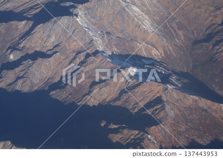 Himalayan mountain ranges seen from a mountain flight airplane window 137443953
