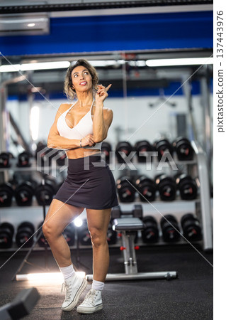 Fit woman pointing up having a new health idea 137443976