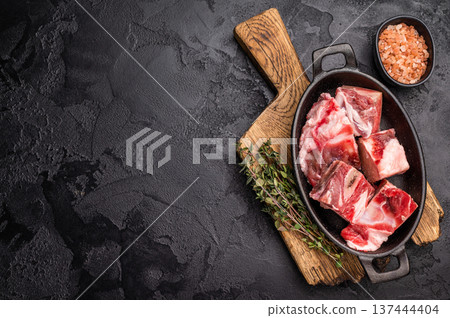 Raw chopped lamb meat with bones, uncooked mutton ready for cooking. black background. top view 137444404