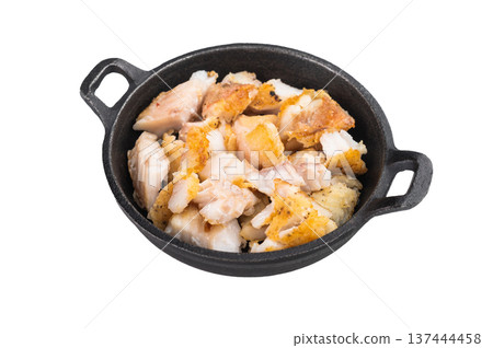 Fried white fish pieces in small skillet isolated on light background. Cooked seafood meal. 137444458