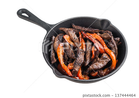 Beef stir fry with bell peppers served in cast iron skillet. Chinese pepper steak style dish isolated on light background. Beef stir fry with bell peppers served in cast iron skillet. Chinese pepper steak style dish isolated on light background. 137444464