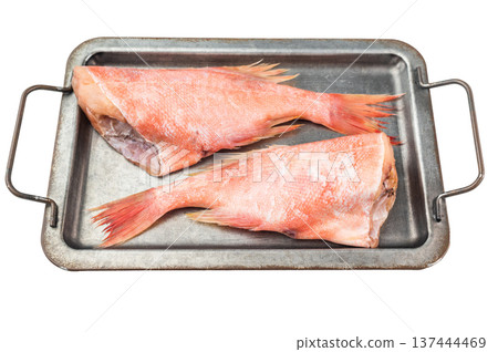 Raw redfish halves on metal tray with lemon and thyme. Fresh seafood ingredient on isolated background with copy space. 137444469