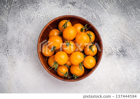 Fresh small yellow cherry tomatoes assortment, mini organic cocktail tomate mix. grey background. top view 137444594