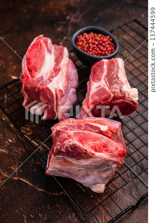 Thick Cut raw Beef Short Ribs, fresh meat with bone. brown background. top view 137444599