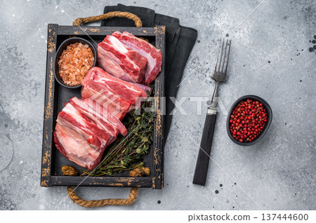 Fresh Raw lamb rib cuts, mutton meat with rib bone in wooden board. grey background. top view 137444600
