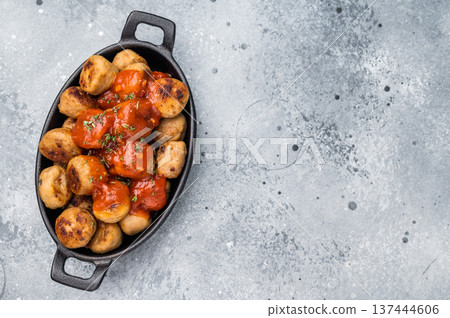 Roast meatballs served with tomato sauce. A classic comfort food in a skillet. grey background. top view 137444606
