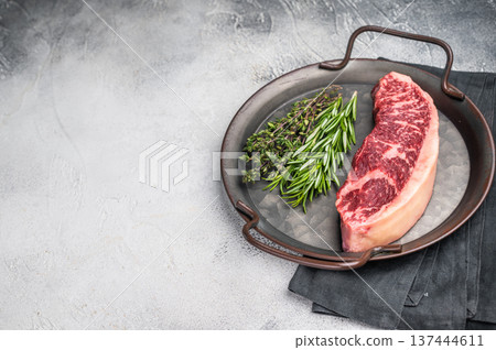 Raw rump cap steak, beef meat, showcasing its rich color and marbling. grey background. top view 137444611