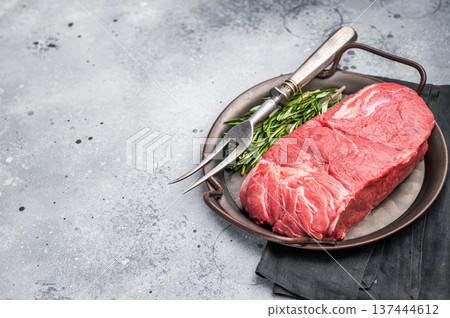 Freshly cut horse meat pieces arranged artfully, showcasing their tender texture and deep red hue, perfect for gourmet recipes. grey background. top view Freshly cut horse meat pieces arranged artfully, showcasing their tender texture and deep red hue, perfect for gourmet recipes. grey background. top view 137444612