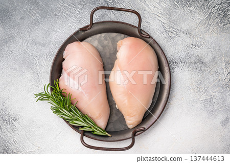 Raw poultry fillets, ready to be seasoned and cooked. These versatile cuts are ideal for grilling, baking, or stir-frying. white background. top view Raw poultry fillets, ready to be seasoned and cooked. These versatile cuts are ideal for grilling, baking, or stir-frying. white background. top view 137444613
