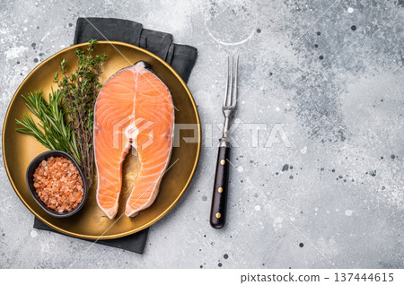 Juicy raw salmon cut, highlighting its natural marbling and freshness. Perfect for grilling or baking to create a mouthwatering meal. grey background. top view Juicy raw salmon cut, highlighting its natural marbling and freshness. Perfect for grilling or baking to create a mouthwatering meal. grey background. top view 137444615