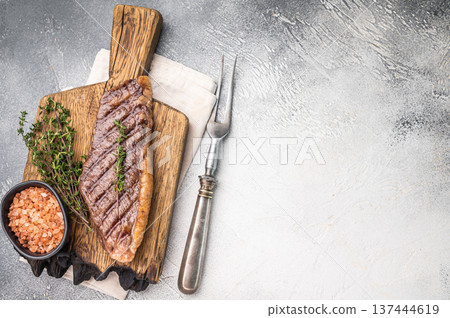 Grilled Top Sirloin, cooked rump beef steak. grey background. top view Grilled Top Sirloin, cooked rump beef steak. grey background. top view 137444619