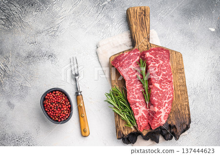 Juicy raw shoulder denver steak, highlighting its tenderness and quality. Perfect for marinating or slow-cooking to enhance its delicious flavor. grey background. top view 137444623