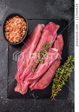 Raw sliced duck breast fillet, uncooked poultry meat. black background. top view 137444629