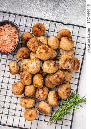Fried Meatballs from beef and pork minced meat garnished with fresh herbs. grey background. top view Fried Meatballs from beef and pork minced meat garnished with fresh herbs. grey background. top view 137444646