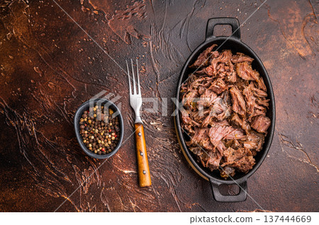 Slow Cooked Pulled Beef, Traditional meat rubbed with spices and smoked. brown background. top view Slow Cooked Pulled Beef, Traditional meat rubbed with spices and smoked. brown background. top view 137444669