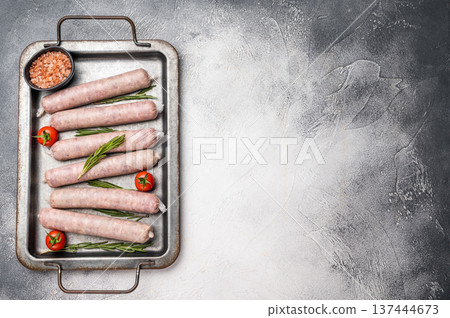 Fresh Sausages with minced pork and veal meat, wurst with herbs. grey background. top view Fresh Sausages with minced pork and veal meat, wurst with herbs. grey background. top view 137444673