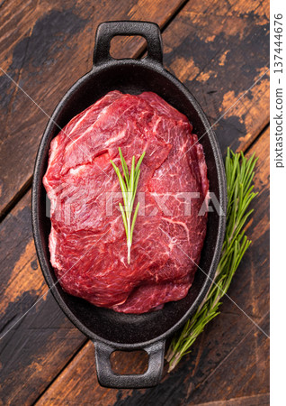 Ready for cooking beef cheeks, raw meat in skillet. wooden background. top view Ready for cooking beef cheeks, raw meat in skillet. wooden background. top view 137444676