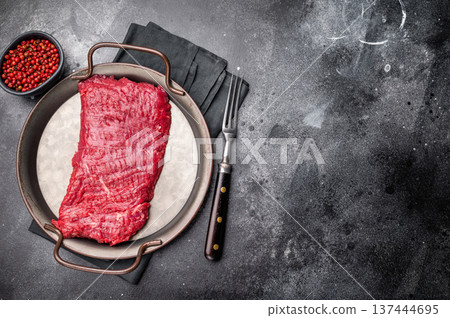 Uncooked flank steak, raw beef flap meat steak. black background. top view 137444695