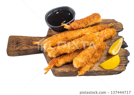 Golden shrimp tempura sticks with lemon slices and asian dipping sauce, crispy seafood finger food styled for restaurant menu design, top view. 137444717