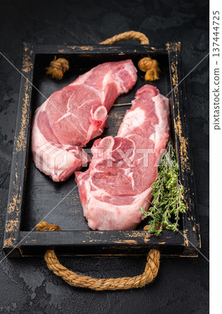 Raw lamb chump chops with bone served on rustic wooden tray with fresh thyme, premium sirloin saddle meat ready for grilling, roasting or gourmet cooking. Raw lamb chump chops with bone served on rustic wooden tray with fresh thyme, premium sirloin saddle meat ready for grilling, roasting or gourmet cooking. 137444725