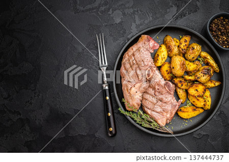 Roasted lamb rump steak with crispy golden potatoes served on dark plate, cooked sirloin saddle meat styled in rustic overhead composition.. Roasted lamb rump steak with crispy golden potatoes served on dark plate, cooked sirloin saddle meat styled in rustic overhead composition.. 137444737