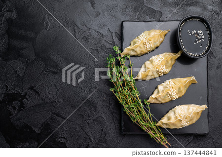 Steamed Japanese Gyoza Dumplings with meat and vegetables. black background. top view 137444841